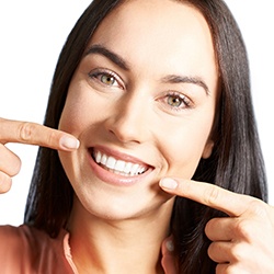 Woman pointing to dental bonding in Louisville. 