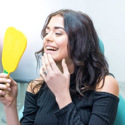 patient admiring her reflection after getting BOTOX® in Louisville, KY