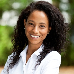 smiling woman in a white collared shirt