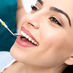 Patient receiving dental checkup in Louisville