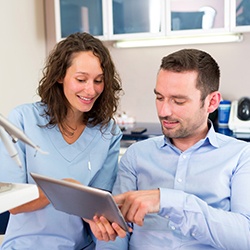 Patient learning about the cost of cosmetic dentistry in Louisville