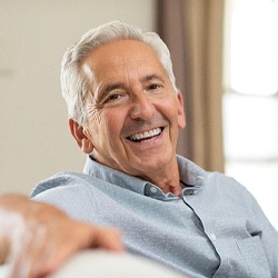 Older man with a dental crown smiling