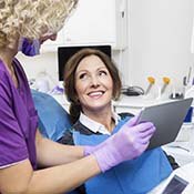 dentist showing a patient their X-rays 