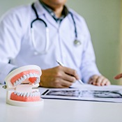 Dentist explaining cost of dentures in Louisville to patient