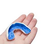 Person holding a custom-made mouthguard