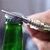 Man using bottle opener to open a beverage