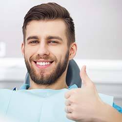 Man visiting emergency dental office in Louisville giving a thumbs up