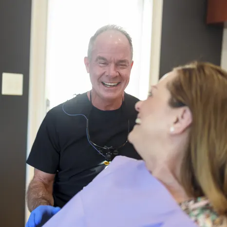 Dr. Bell laughing with a patient