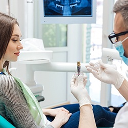 dentist explaining dental implants to patient