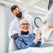 mature woman smiling at dentist’s office 