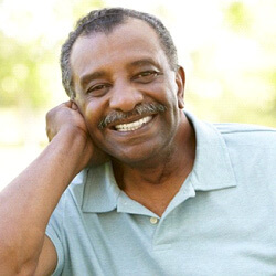Man smiling in louisville with his implant dentures