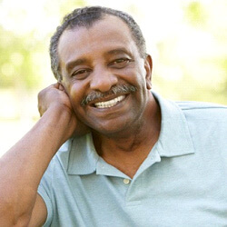 Man smiling in Louisville with his implant dentures