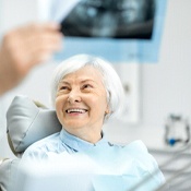 Woman smiling at implant dentist in Louisville