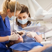Dentist placing dental implant in Louisville