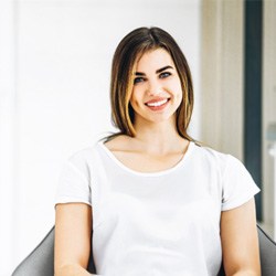 Female patient in white shirt at dentist’s office