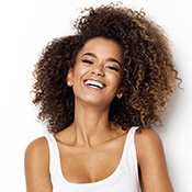 woman smiling after working with an Invisalign dentist in Louisville