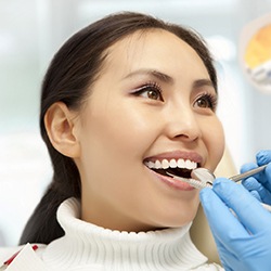 Woman with beautiful teeth after a smile makeover.