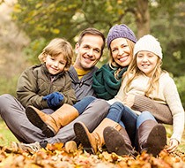 family smiling outdoors