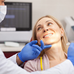 woman smiling in dental chair up at dentist