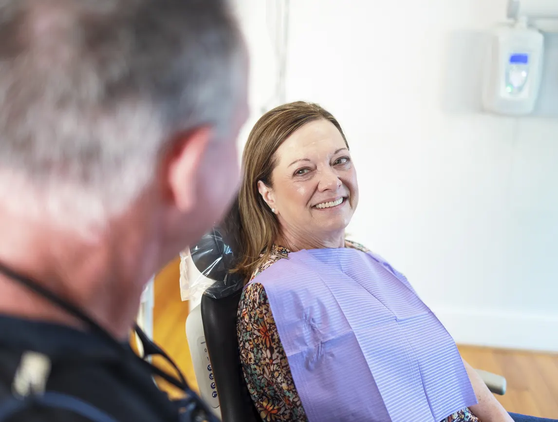 Dr. Bell talking with a smiling patient