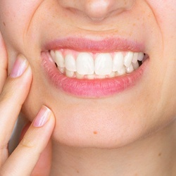 Close up of woman’s smile in pain