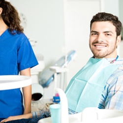 Man smiling while sitting in dental chair