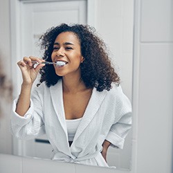 a woman brushing her teeth