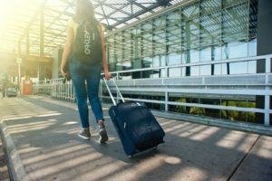 Woman using summer oral health tips while traveling