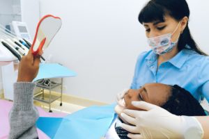 Woman at dentist replacing a metal crown