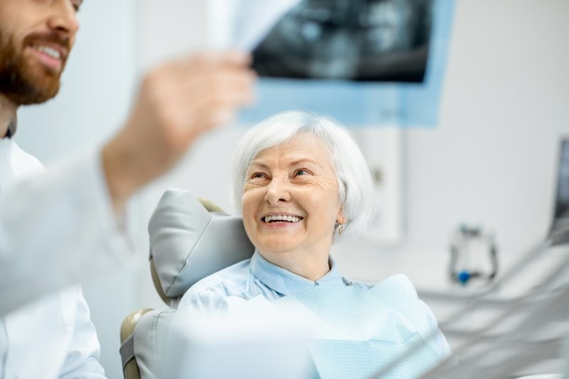 dentist answering questions about dental implants lifespan