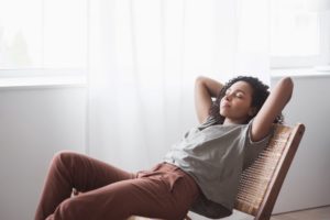Woman relaxing at home after All-on-4 surgery