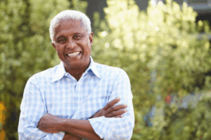 Man standing outdoors and smiling brightly with straight teeth